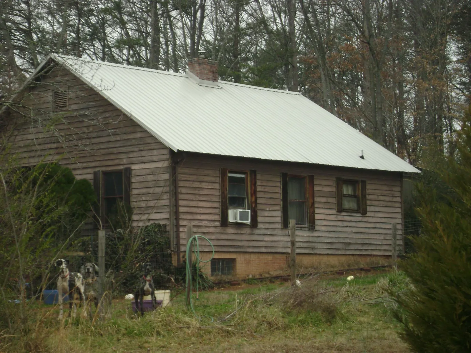 White metal roof on an old wood sided farmhouse, from a Metal Roof Installation job in Center Barnstead